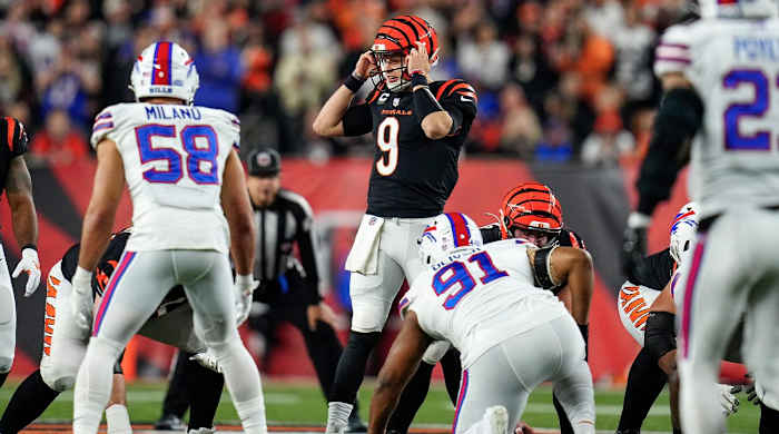 Cincinnati Bengals quarterback Joe Burrow (9) resets a play before running a QB sneak for a first down in the first quarter of the NFL Week 17 game between the Cincinnati Bengals and the Buffalo Bills at Paycor Stadium in Downtown Cincinnati on Monday, Jan. 2, 2023. The game was suspended with suspended in the first quarter after Buffalo Bills safety Damar Hamlin (3) was taken away in an ambulance following a play.